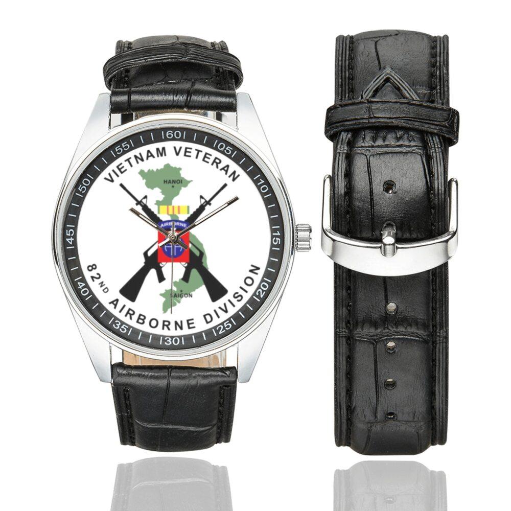 Men's casual watch with a round dial featuring the Vietnam Veteran 82nd Airborne emblem, silver-tone case and black leather strap, shown with the strap to the side.