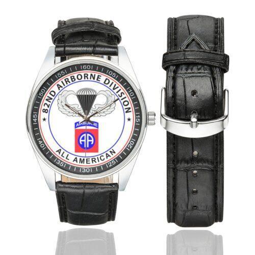 Men's casual watch with a round dial featuring the 82nd Airborne emblem, silver-tone case and black leather strap, shown with the strap to the side.