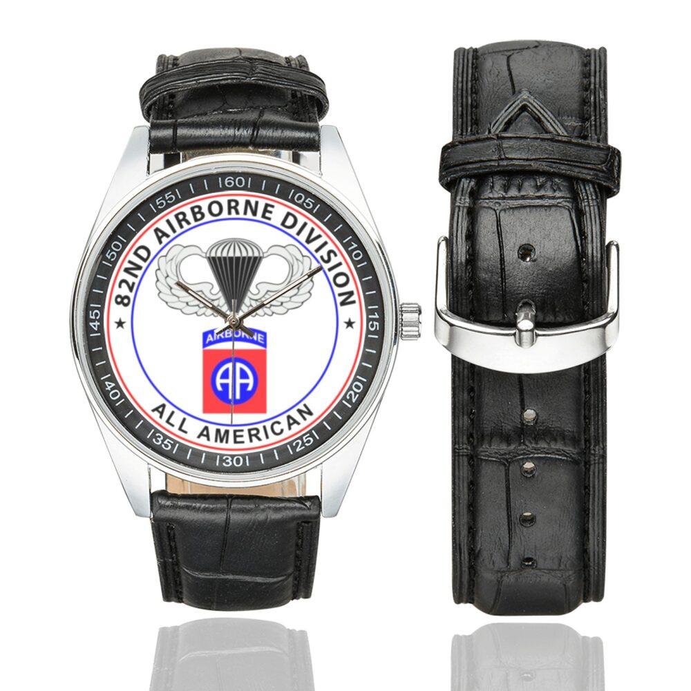 Men's casual watch with a round dial featuring the 82nd Airborne emblem, silver-tone case and black leather strap, shown with the strap to the side.