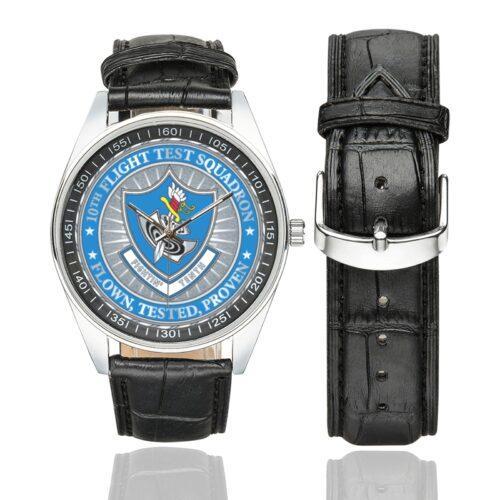 Men's casual watch with a round dial featuring the USAF 10th Flight Test Squadron emblem, silver-tone case and black leather strap, shown with the strap to the side.