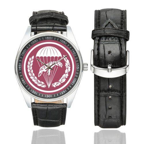 Men's casual watch with a round dial featuring the Poland 6th Airborne Brigade Polish Paratrooper emblem, silver-tone case and black leather strap, shown with the strap to the side.
