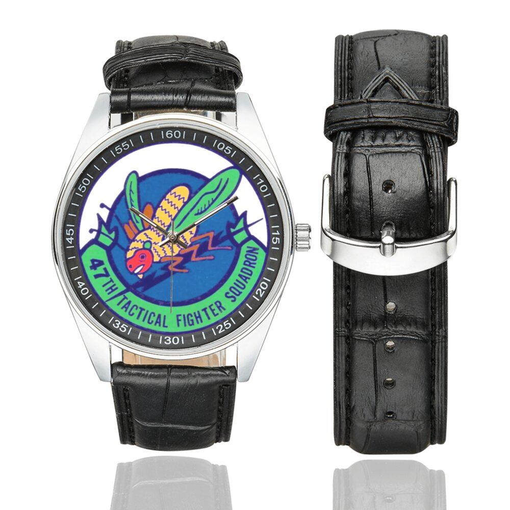 Men's casual watch with a round dial featuring the USAF 47th Tactical Fighter Squadron emblem, silver-tone case and black leather strap, shown with the strap to the side.