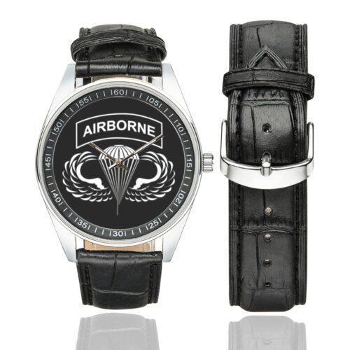 Men's casual watch with a round dial featuring the Airborne emblem, silver-tone case and black leather strap, shown with the strap to the side.