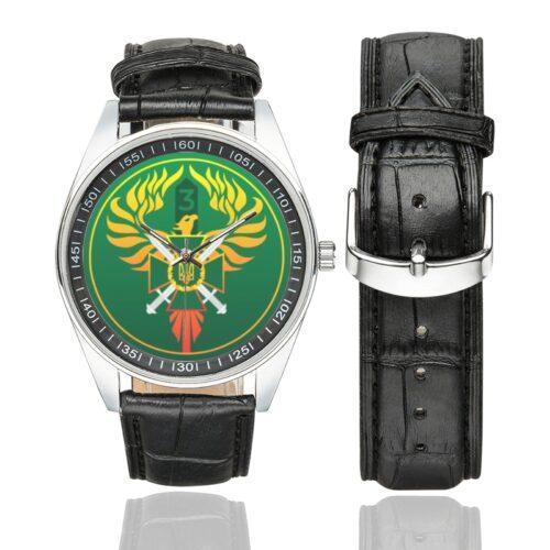 Men's casual watch with a round dial featuring the Ukraine 3rd Border Detachment Pomsta Brigade emblem, silver-tone case and black leather strap, shown with the strap to the side.