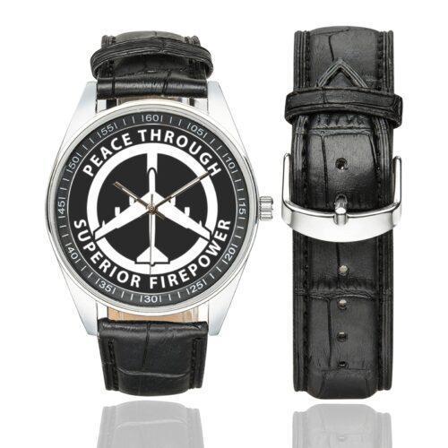 Men's casual watch with a round dial featuring the Peace Through Superior Firepower B52 Bomber emblem, silver-tone case and black leather strap, shown with the strap to the side.