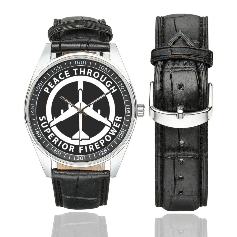 Men's casual watch with a round dial featuring the Peace Through Superior Firepower B52 Bomber emblem, silver-tone case and black leather strap, shown with the strap to the side.