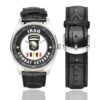 Men's casual watch with a round dial featuring the US Army 101st Airborne Division Combat Veteran emblem, silver-tone case and black leather strap, shown with the strap to the side.