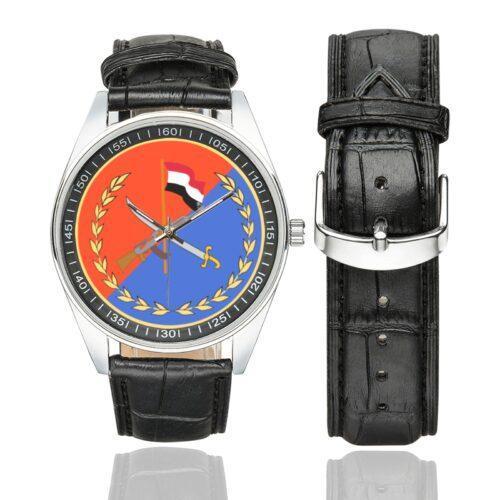 Men's casual watch with a round dial featuring the Yemeni Republican Guard SSI.svg emblem, silver-tone case and black leather strap, shown with the strap to the side.