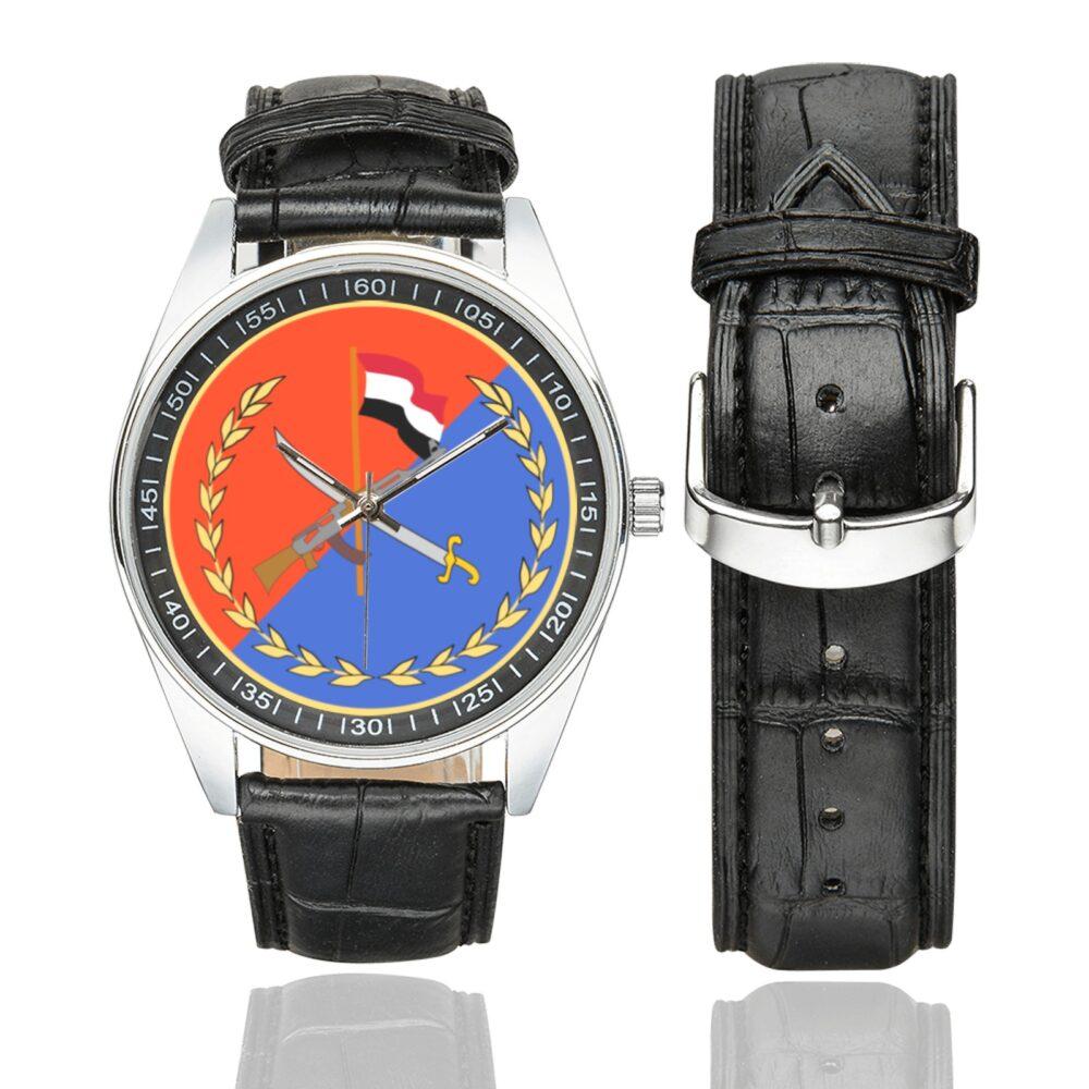 Men's casual watch with a round dial featuring the Yemeni Republican Guard SSI.svg emblem, silver-tone case and black leather strap, shown with the strap to the side.