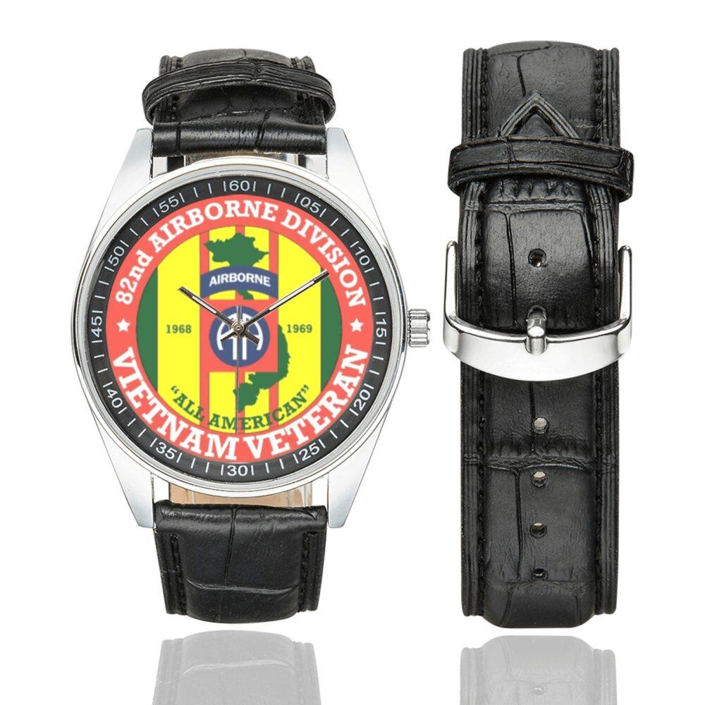 Men's casual watch with a round dial featuring the US Army 82nd Airborne Division Vietnam Veteran emblem, silver-tone case and black leather strap, shown with the strap to the side.