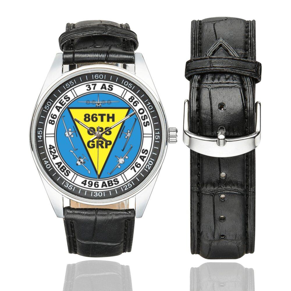 Men's casual watch with a round dial featuring the USAF 86th Operations Group emblem, silver-tone case and black leather strap, shown with the strap to the side.