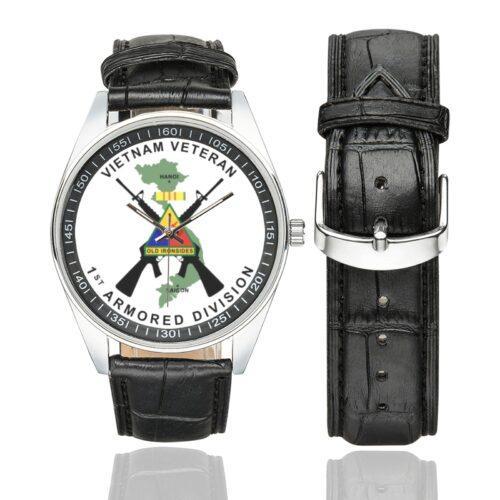 Men's casual watch with a round dial featuring the Vietnam Veteran 1st Armored Division emblem, silver-tone case and black leather strap, shown with the strap to the side.