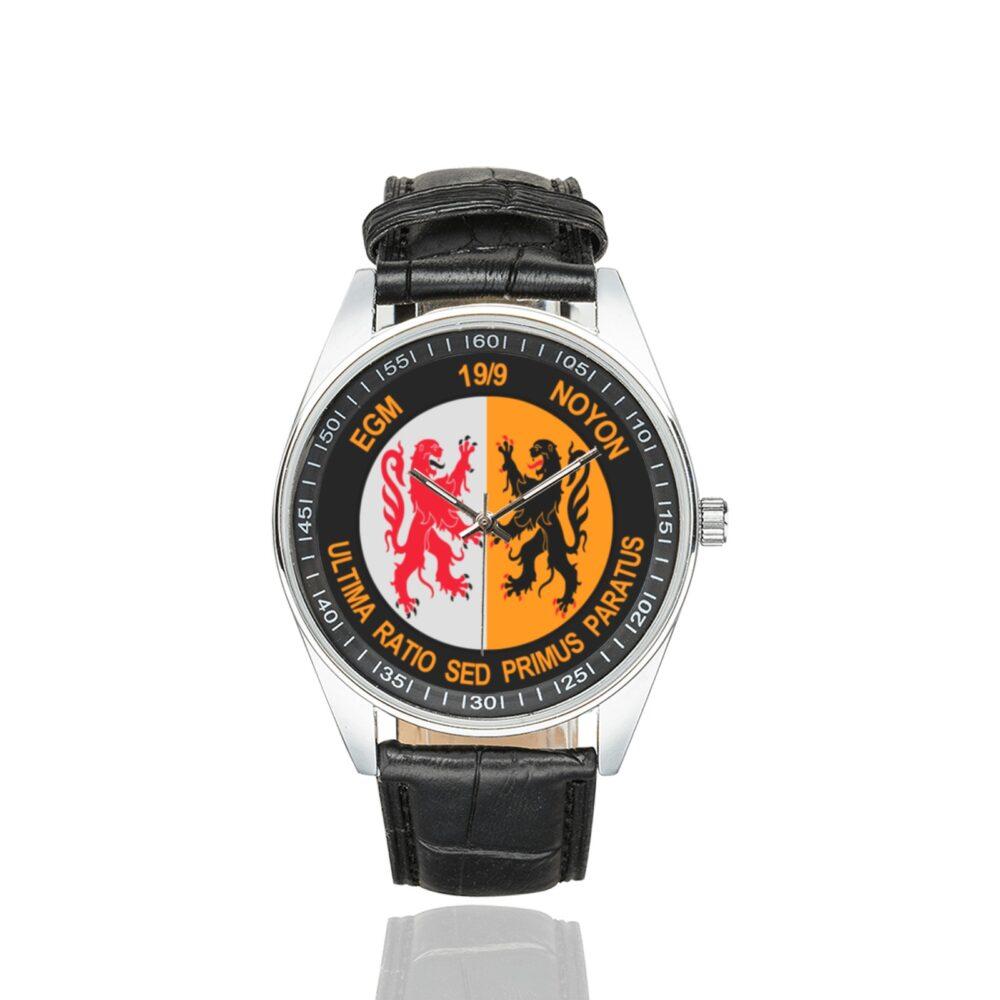 Men's casual watch with a round dial featuring the EGM 19-9 Noyon emblem, silver-tone case and black leather strap.