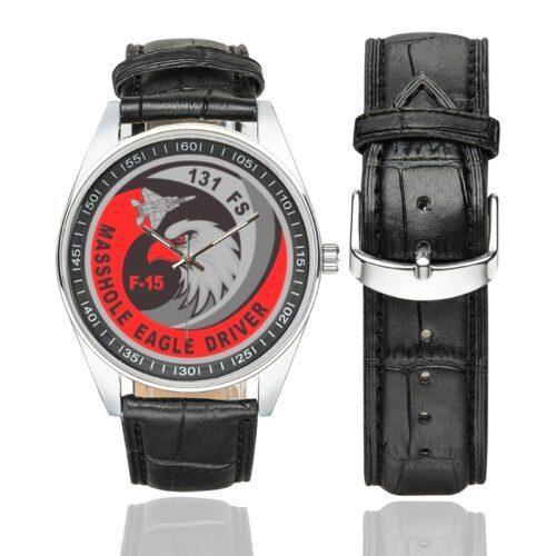 Men's casual watch with a round dial featuring the USAF 131st Fighter Squadron Masshole Eagle Driver emblem, silver-tone case and black leather strap, shown with the strap to the side.