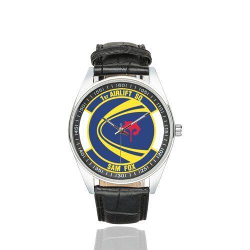 Men's casual watch with a round dial featuring the USAF 1st Airlift Squadron- emblem, silver-tone case and black leather strap.