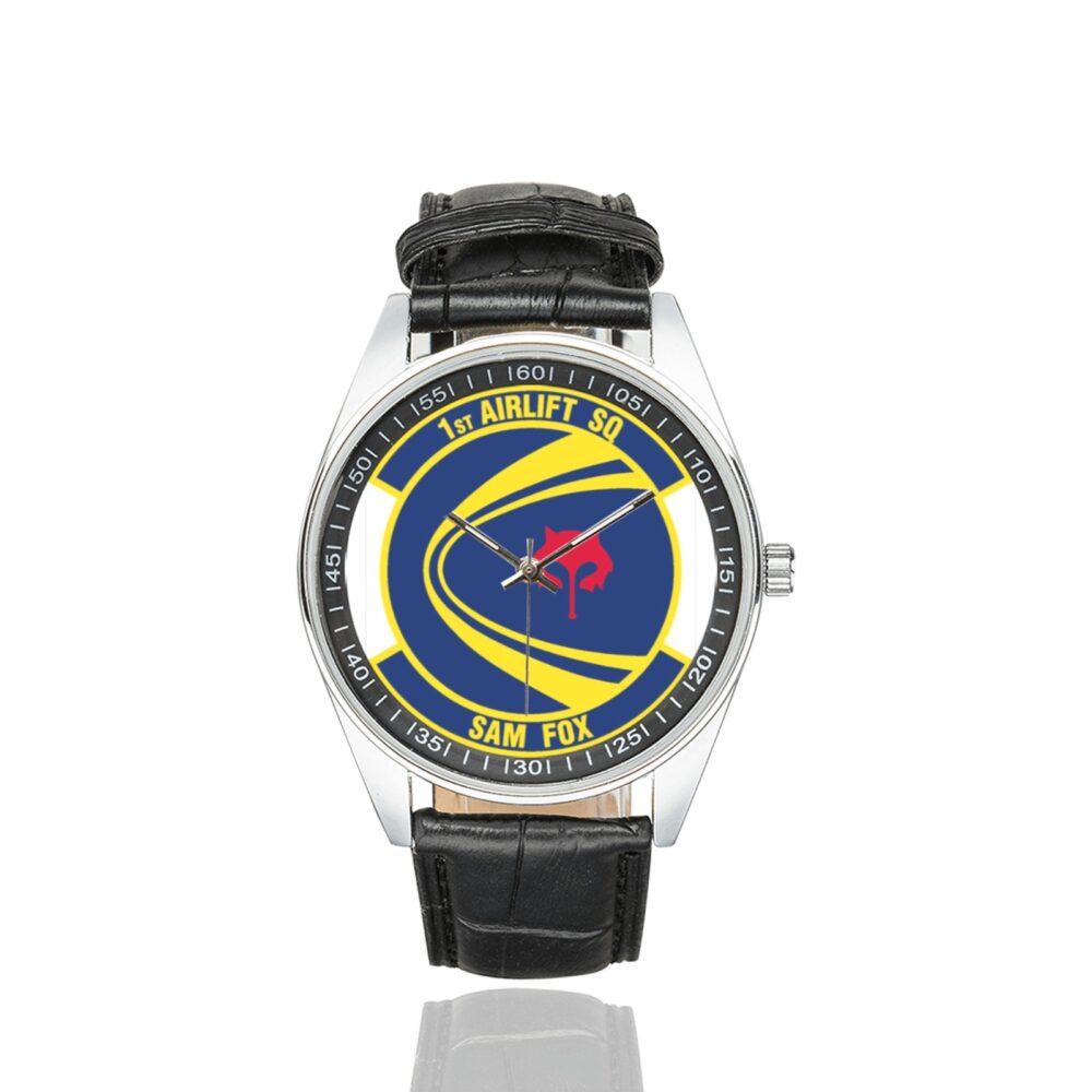 Men's casual watch with a round dial featuring the USAF 1st Airlift Squadron- emblem, silver-tone case and black leather strap.