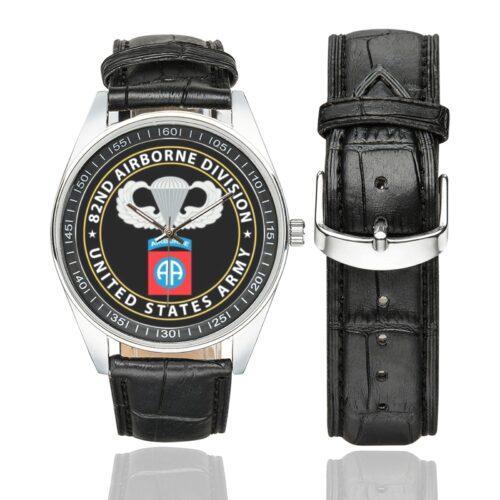 Men's casual watch with a round dial featuring the 82nd Airborne emblem, silver-tone case and black leather strap, shown with the strap to the side.