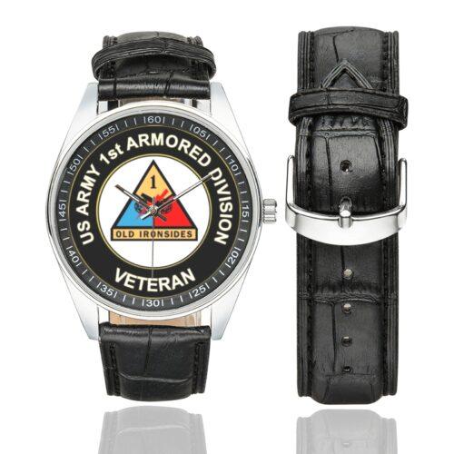 Men's casual watch with a round dial featuring the US Army 1st Armored Division Veteran emblem, silver-tone case and black leather strap, shown with the strap to the side.