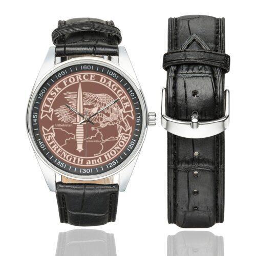 Men's casual watch with a round dial featuring the Task Force Dagger emblem, silver-tone case and black leather strap, shown with the strap to the side.