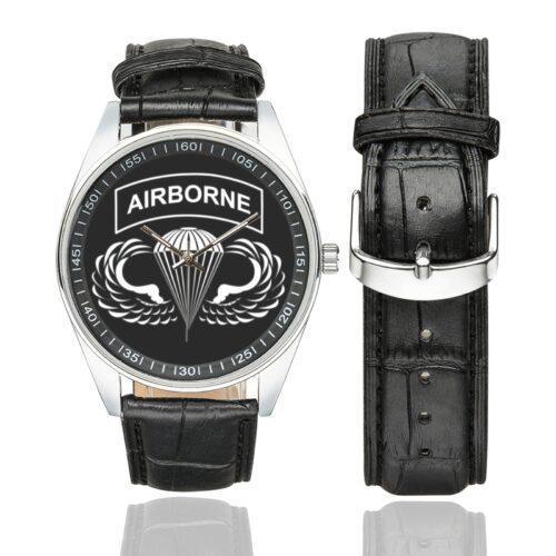 Men's casual watch with a round dial featuring the US Army Airborne Veteran emblem, silver-tone case and black leather strap, shown with the strap to the side.