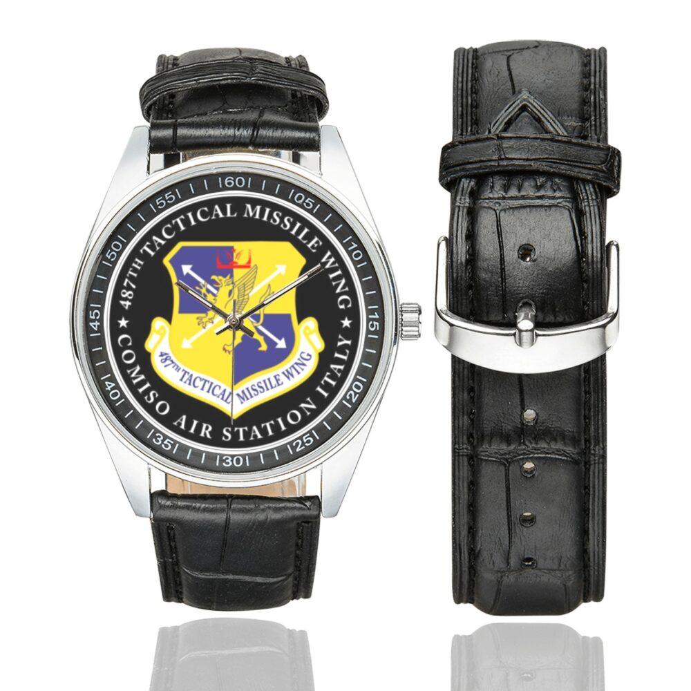 Men's casual watch with a round dial featuring the GLCM 487th Tactical Missile Wing emblem, silver-tone case and black leather strap, shown with the strap to the side.