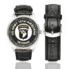 Men's casual watch with a round dial featuring the US Army 101st Airborne Division Veteran emblem, silver-tone case and black leather strap, shown with the strap to the side.