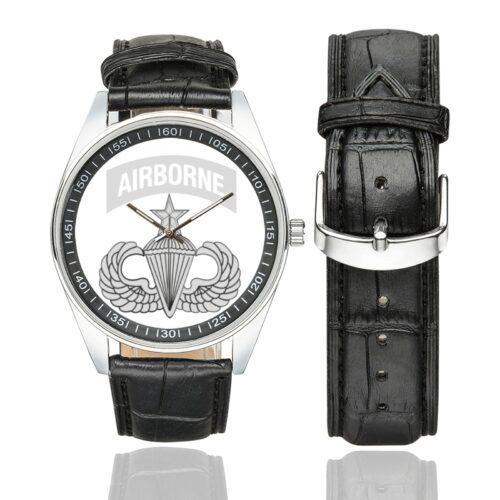 Men's casual watch with a round dial featuring the US Army Airborne Jumpmaster Wings emblem, silver-tone case and black leather strap, shown with the strap to the side.
