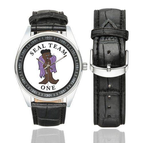 Men's casual watch with a round dial featuring the SEAL Team 1 emblem, silver-tone case and black leather strap, shown with the strap to the side.