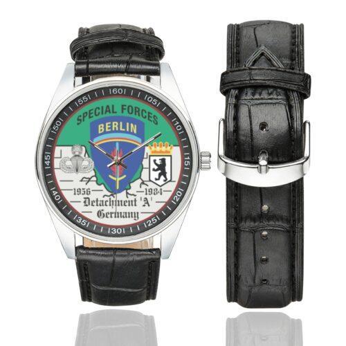 Men's casual watch with a round dial featuring the US Army Special Forces Detachment A Berlin Brigade emblem, silver-tone case and black leather strap, shown with the strap to the side.