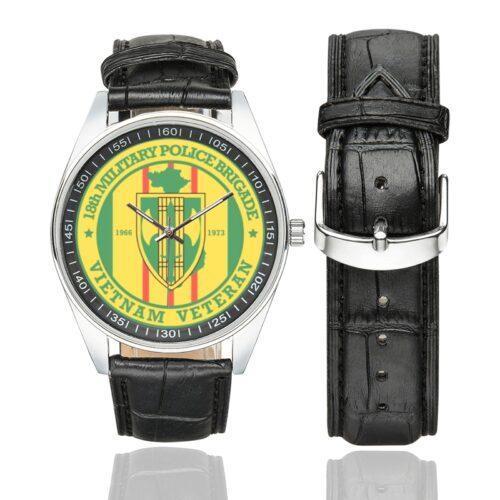 Men's casual watch with a round dial featuring the US Army 18th Military Police BDE Vietnam Veteran emblem, silver-tone case and black leather strap, shown with the strap to the side.