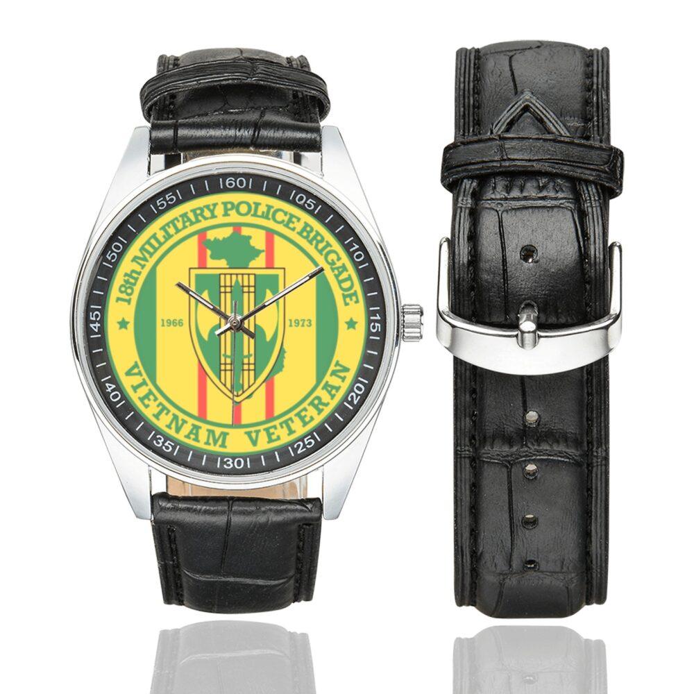 Men's casual watch with a round dial featuring the US Army 18th Military Police BDE Vietnam Veteran emblem, silver-tone case and black leather strap, shown with the strap to the side.