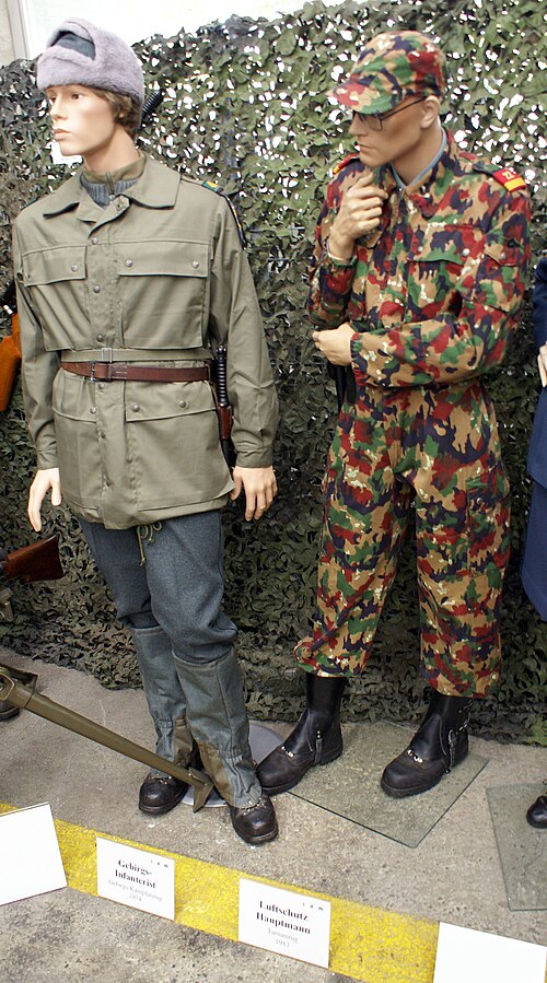 Two Swiss Army mannequins at the Swiss Army Museum: left, a mountain infantryman in the 1973 battle suit; right, a captain in the 1983 TAZ 83 camouflage suit with field cap.