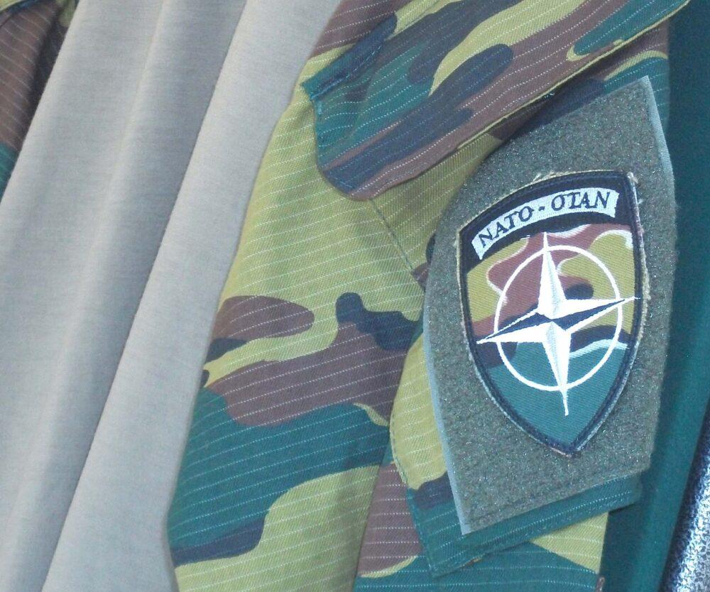 Belgian jigsaw camouflage on an under-body-armour uniform item with NATO-OTAN insignia