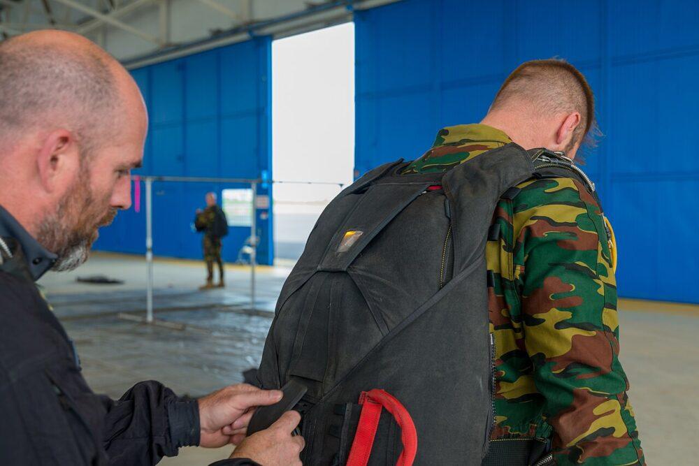 Belgian special operations paratrooper packing his parachute, wearing jigsaw camouflage
