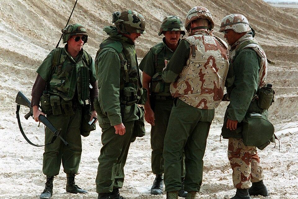 Naval personnel during a camp defence drill wearing the Desert Night Camouflage pattern helmet cover.