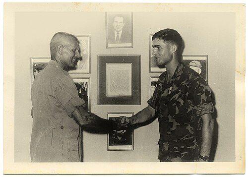 Robert Mueller receiving an award in ERDL uniform in South Vietnam, 1969