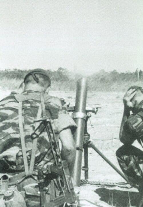 Foreign Legion paratroopers in lizard camouflage firing a mortar at Kolwezi