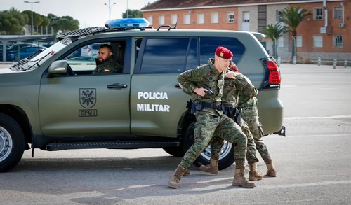 Spanish Army military police soldiers in M09 boscoso camouflage beside a Toyota Land Cruiser, 2023.
