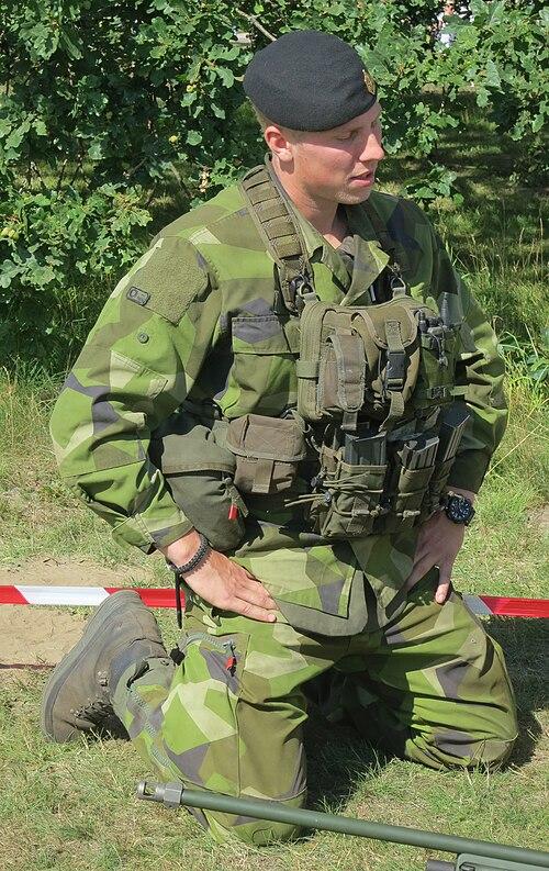 Swedish soldier wearing the M90 field uniform with a combat vest and helmet