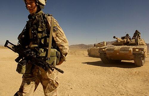 Swedish soldier in the M90K desert pattern assisting a CV90-40C armoured vehicle during exercises