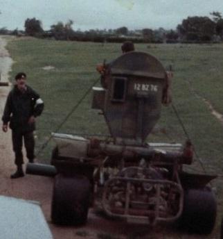 Rhodesian Pookie landmine detection vehicle deployed in 1979, seen from the rear with a soldier standing alongside on a grass field