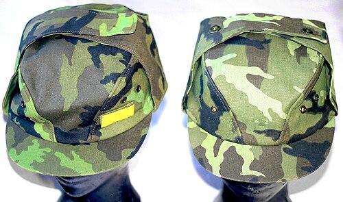 Two Czech army field caps: a standard vz.95 cap (left) and a vz.85 airborne/para cap (right) in the green leaf pattern.