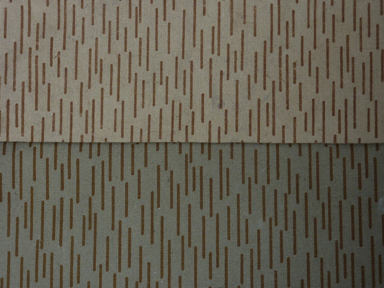 Close-up comparison of two East German Strichtarn camouflage fabric samples, an earlier printing with thinner brown dashes above a later, denser and darker printing