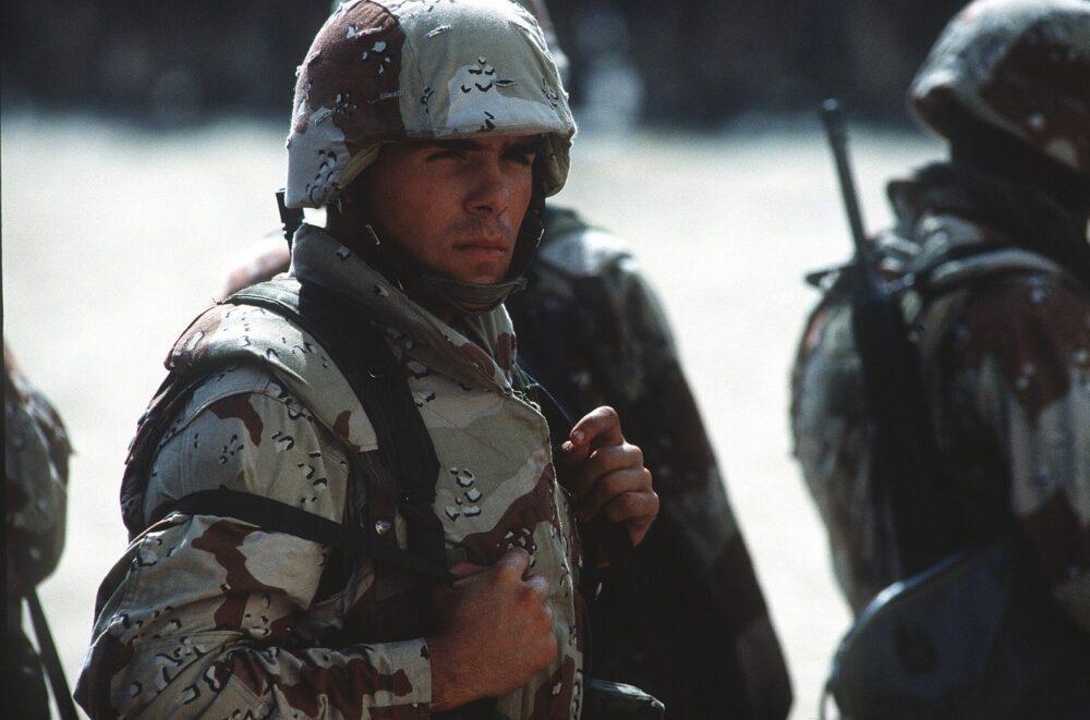 US Marine in six-colour desert camouflage moving out with his unit in Saudi Arabia during Operation Desert Shield, January 1991.