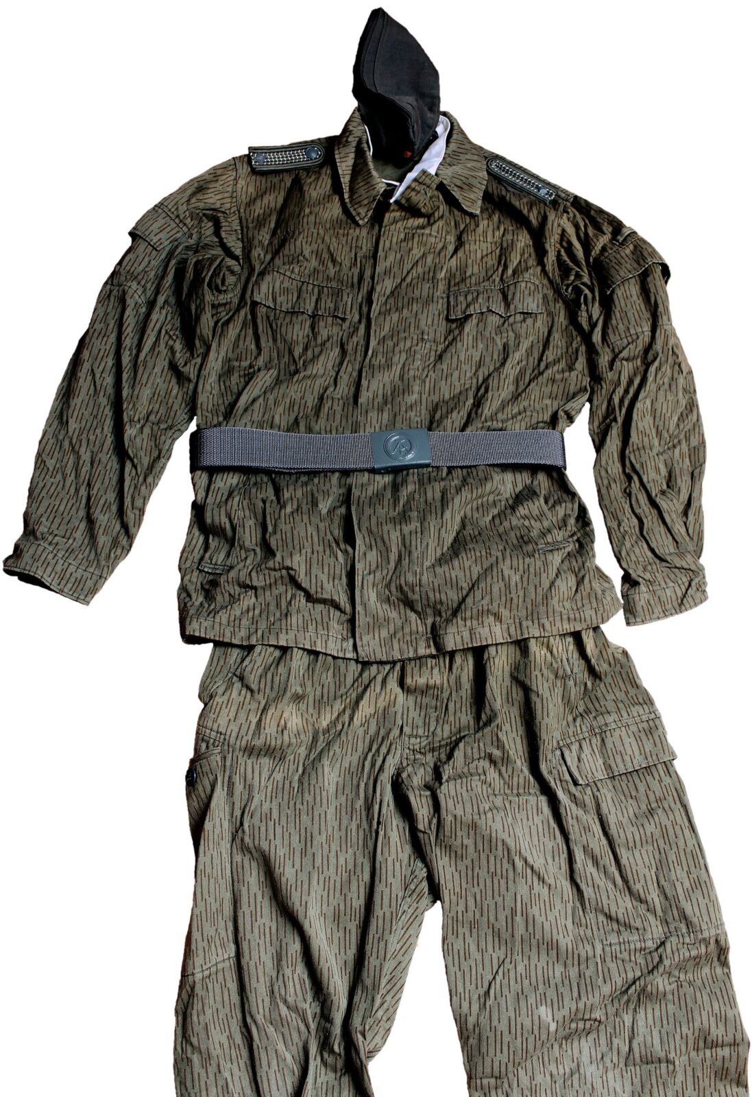 Summer field-service uniform of the East German National People's Army presented flat, jacket, trousers, grey belt, black side cap and shoulder boards, in fine vertical rain dashes on a light grey-green ground