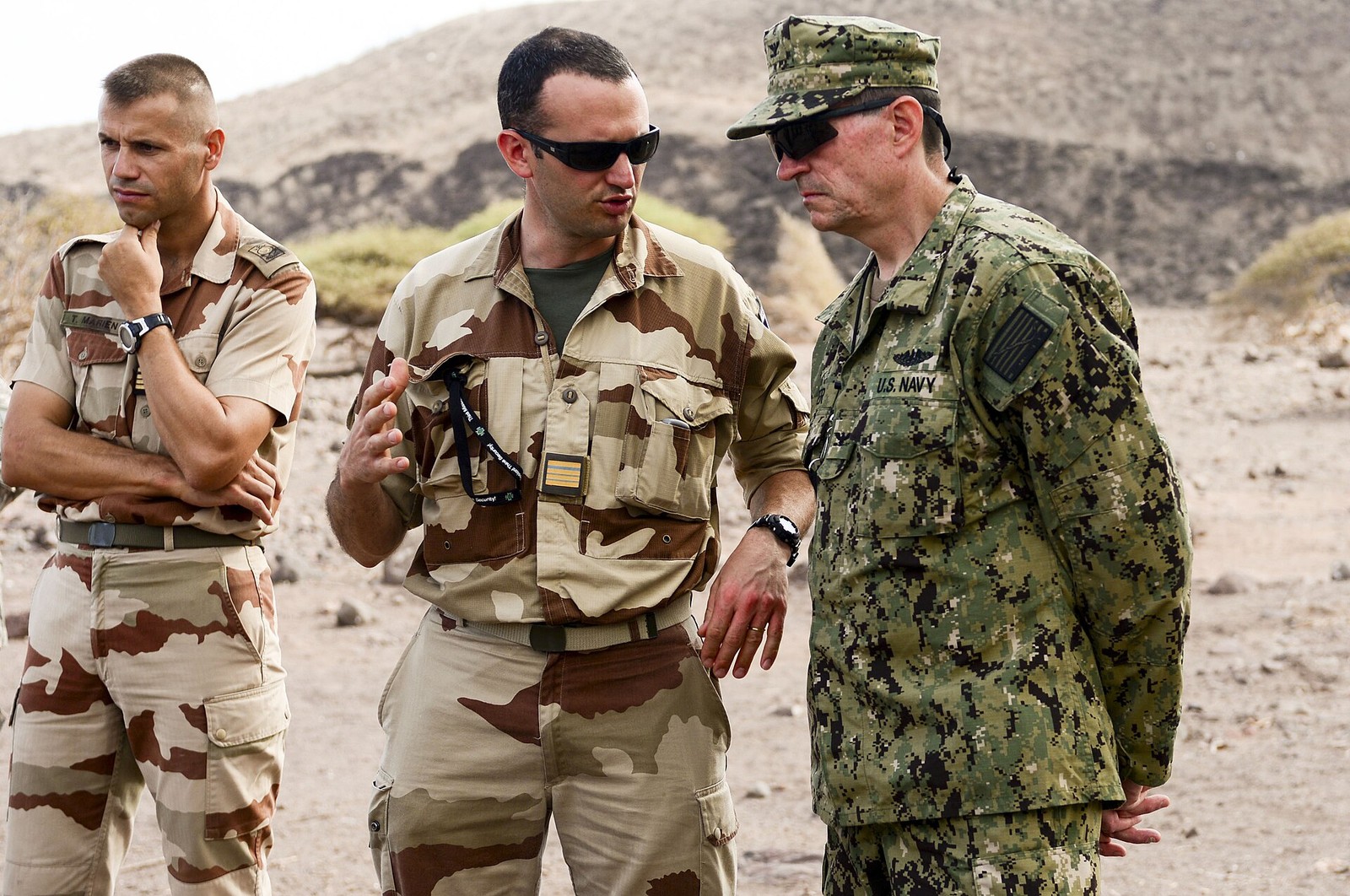 Two French Marines in desert camouflage talking with a U.S. Navy officer during a desert training course in Djibouti, 2013