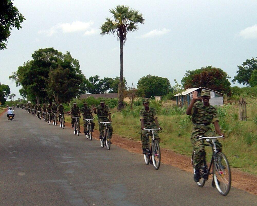 Column of LTTE cadres on bicycles in camouflage uniforms, northern Sri Lanka, May 2004