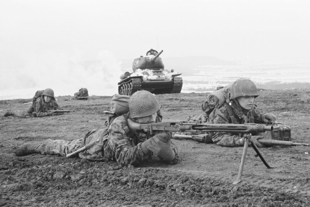 Austrian Bundesheer soldiers in spotted camouflage with a machine gun team and a T-34 tank during a 1958 demonstration