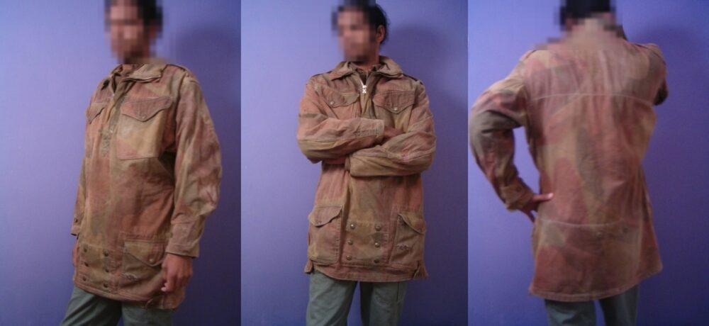 A 2nd Pattern 1944 Denison parachute smock in heavily faded condition, worn by a model whose face is blurred