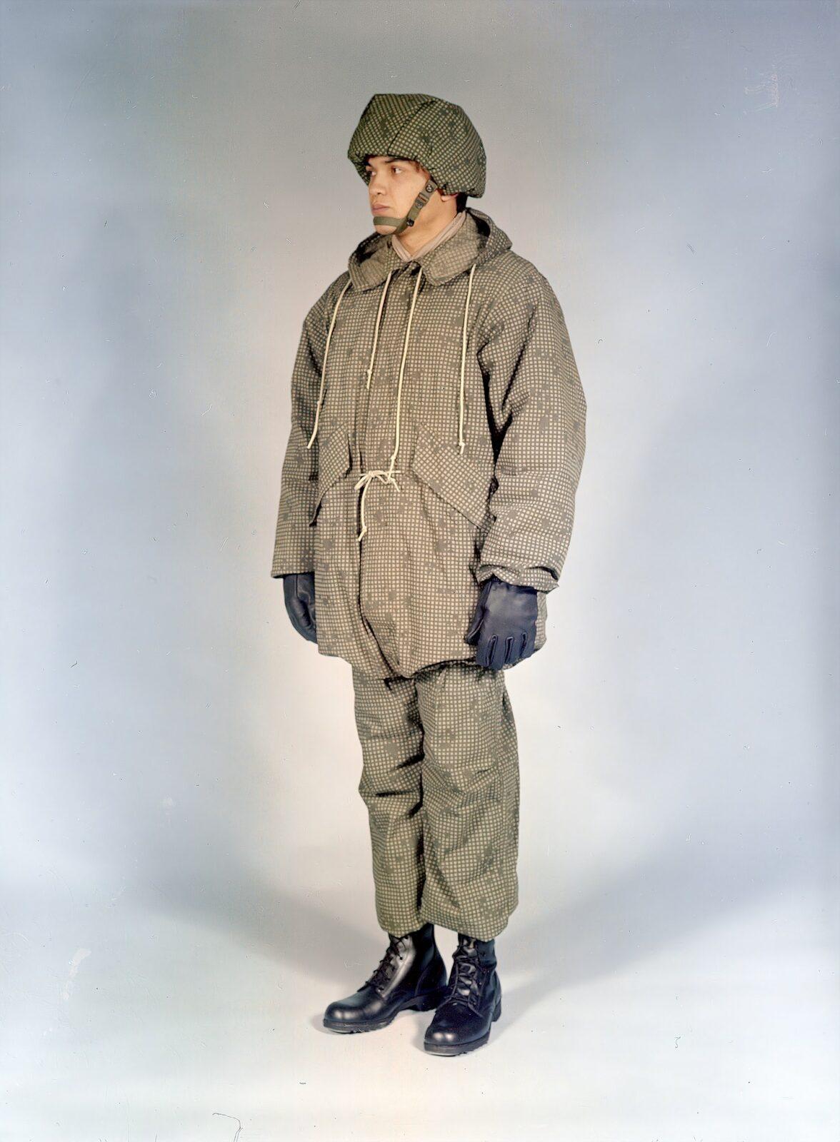 A US Army soldier wearing the 1978 Desert Night Camouflage uniform set: a faint two-colour night grid on an olive ground